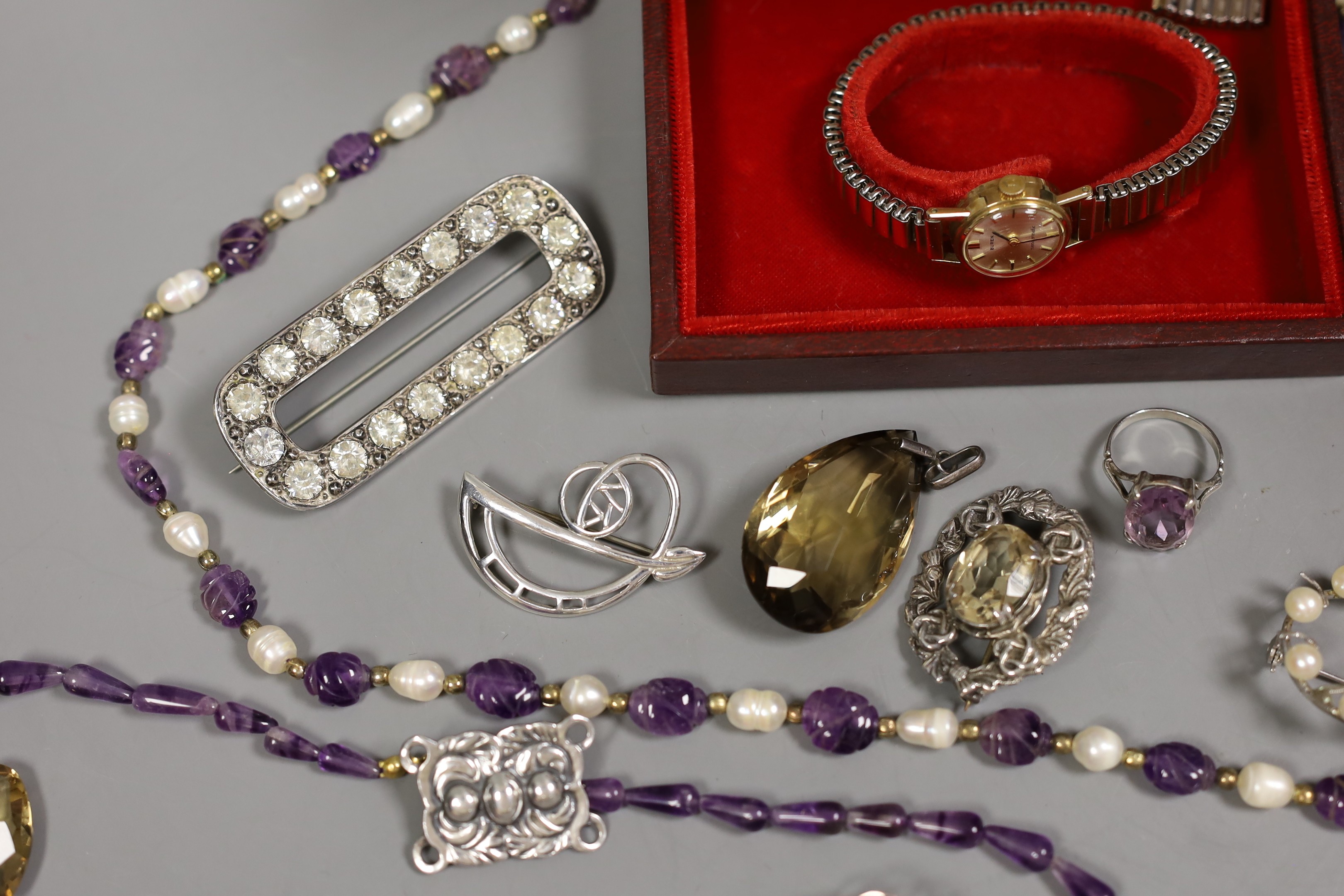 A late Victorian silver and paste set oval brooch, a lady's 9ct gold Buren manual wind wrist watch, an amethyst and freshwater? pearl necklace and other jewellery including amethyst ring and citrine set pendant.